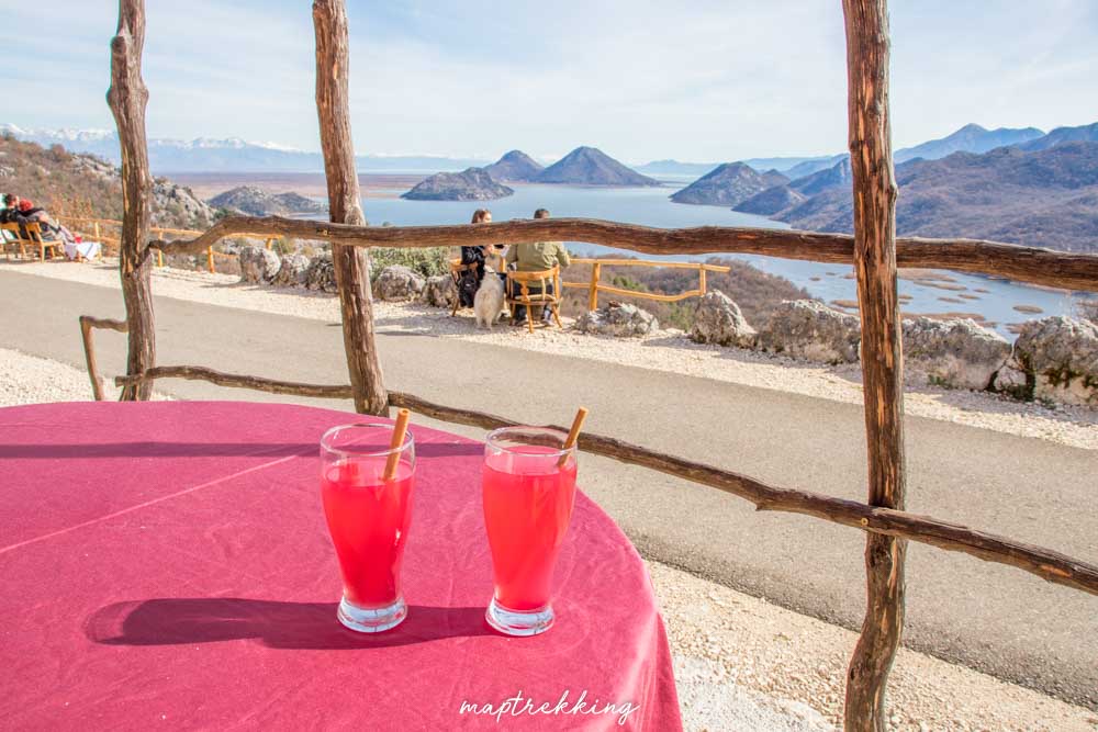 two glasses of traditional Montenegrin pomegranate juice overlooking Lake Skadar and Montenegrin mountains
