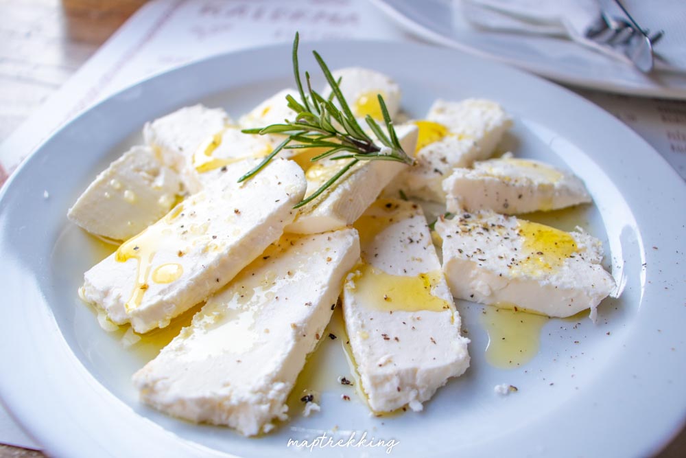 a starter of local sheep cheese that was freshly cut and topped with olive oil rosemary salt and pepper