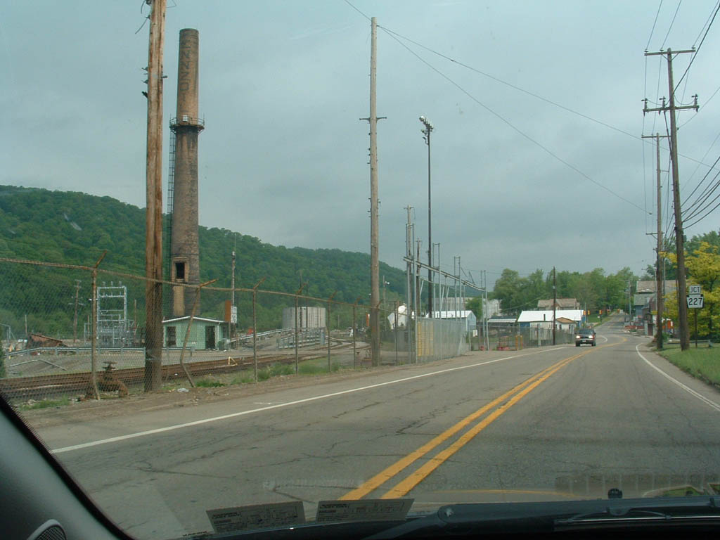 why traveling is good for the soul is this vision of route 8 leading through Rouseville, Pennsylvania. Rusted over Penzoil factory near junction 227. Green trees in the background and quite road in the foreground