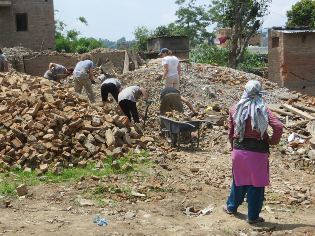 Ellis removing rubble in nepal. A group of volunteers working together.